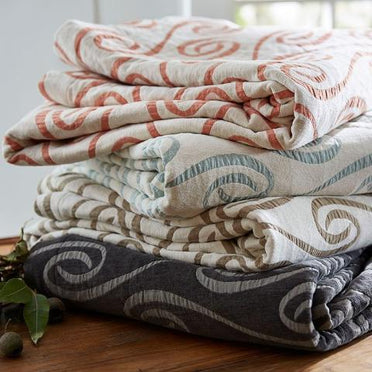Stack of the many colors the Adlon coverlet is available in. 