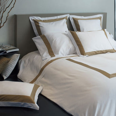 Aida bedding collection displayed on bed in caramel color.